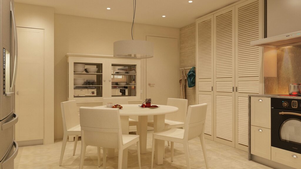 Cocina moderna y elegante en Barcelona con diseño de alta gama Cocina contemporánea en Barcelona con mesa de comedor redonda blanca, sillas blancas y muebles de almacenamiento con puertas de cristal, iluminada con luz natural y equipada con electrodomésticos de alta calidad.