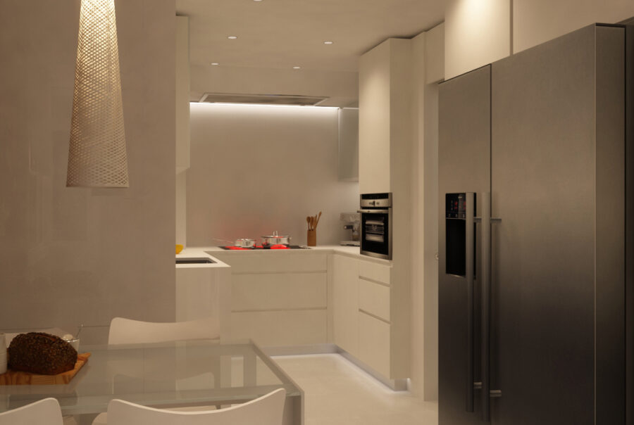 Cocina de diseño interior moderno en Barcelona, con mobiliario elegante de colores claros, electrodomésticos integrados y una mesa de comedor de vidrio en un ambiente iluminado naturalmente.