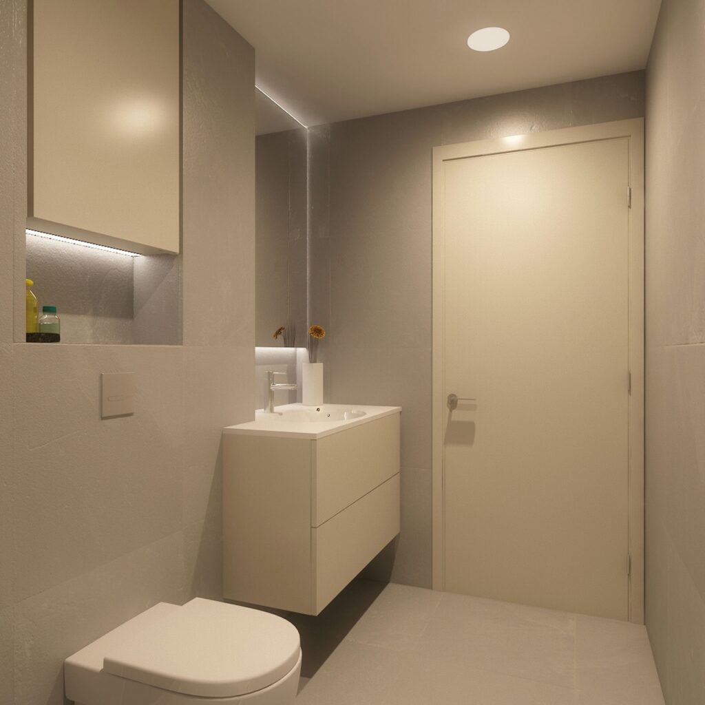 Diseño de interiores de baño moderno en Barcelona con elementos de alta gama Baño moderno en Barcelona con diseño contemporáneo, muebles elegantes en blanco, paredes suaves y suelo minimalista. Iluminación cálida y espejo retroiluminado añaden sofisticación al espacio.