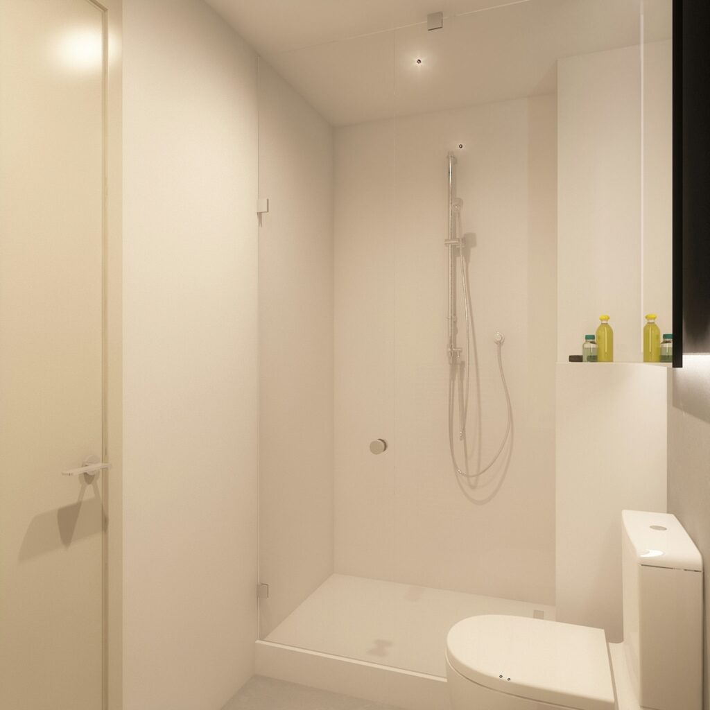 Diseño de baño moderno y contemporáneo en Barcelona con acabados de alta calidad Baño minimalista en Barcelona, destacando una ducha moderna con mampara de cristal y un inodoro elegante, todo en un acabado blanco limpio.