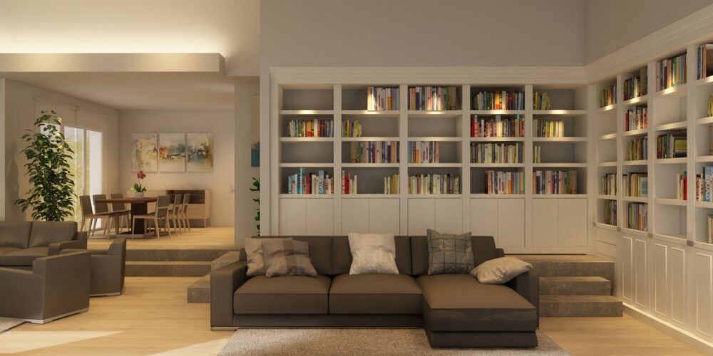 Sala de estar moderna en Barcelona con sofá seccional marrón, estantería y mesa de comedor de madera, iluminada por luz natural.