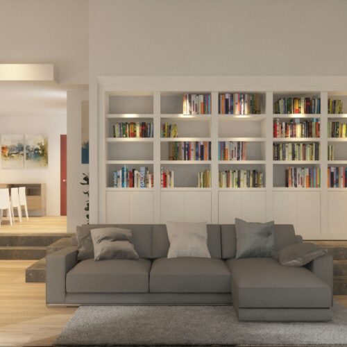 Salón-comedor en Sant Cugat del Vallès: Amplio salón moderno en Barcelona con sofá gris, sillón negro, y estantería integrada, iluminado por luz natural.