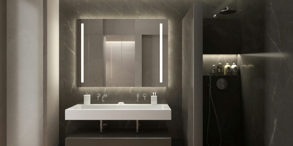 Baño moderno en Barcelona que destaca un lavabo de diseño limpio, mueble oscuro y un espejo contemporáneo, rodeado de luz natural y área de ducha elegante.