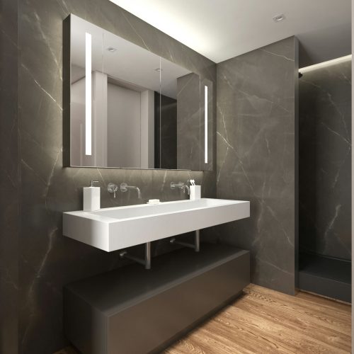 Moderno baño de diseño de interiores de alta gama en Barcelona, con revestimiento de mármol oscuro, encimera blanca y mueble gris. Espacio contemporáneo con espejo con iluminación LED, grifos minimalistas y suelo de madera, combinando funcionalidad y estética en un entorno elegante.