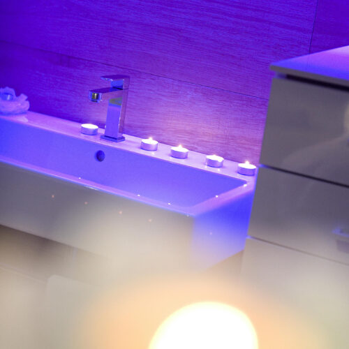 Baño minimalista con bañera y luces suaves