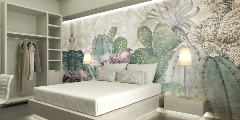Dormitorio contemporáneo en Barcelona con un diseño minimalista, cama moderna, cabecera en tonos neutros, lámparas de noche elegantes, cojines decorativos y un vibrante mural de cactus. Espacio iluminado naturalmente con acabados en madera clara y armario organizado, priorizando funcionalidad y estética.