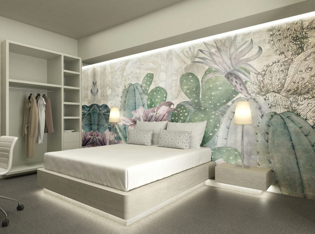 Diseño Moderno de Dormitorio Minimalista en Barcelona Dormitorio contemporáneo en Barcelona con un diseño minimalista, cama moderna, cabecera en tonos neutros, lámparas de noche elegantes, cojines decorativos y un vibrante mural de cactus. Espacio iluminado naturalmente con acabados en madera clara y armario organizado, priorizando funcionalidad y estética.