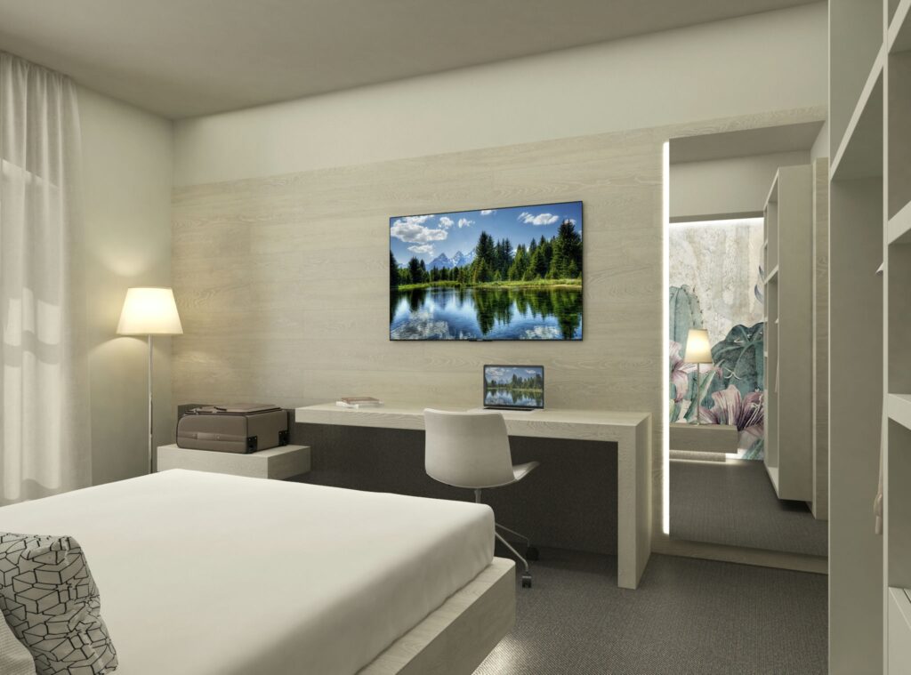 Diseño de interiores moderno en Barcelona: Un dormitorio sofisticado Interior de un dormitorio contemporáneo en Barcelona con cama minimalista, escritorio elegante y televisor montado, iluminado con luz natural a través de cortinas sheer