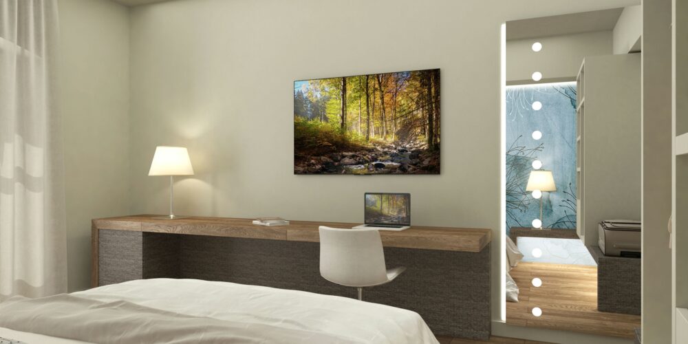 Dormitorios: Dormitorio contemporáneo en Barcelona con cama blanca, escritorio de madera y monitor, obra de arte de paisaje natural en la pared, y espejo con luces led, destacando el diseño funcional y elegante. Dormitorios personalizados