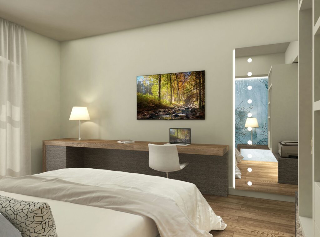 Moderno dormitorio de diseño de interiores en Barcelona con estética contemporánea Dormitorios: Dormitorio contemporáneo en Barcelona con cama blanca, escritorio de madera y monitor, obra de arte de paisaje natural en la pared, y espejo con luces led, destacando el diseño funcional y elegante. Dormitorios personalizados