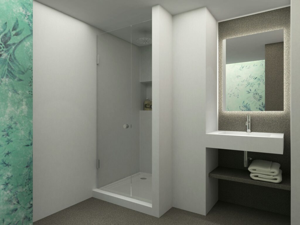 Diseño de baño moderno y contemporáneo en Barcelona con pared floral verde Baño contemporáneo en Barcelona con paredes blancas y una pared verde floral, ducha de cristal, lavabo minimalista y espejo con iluminación LED, destacando funcionalidad y estética del diseño de interiores de alta gama.