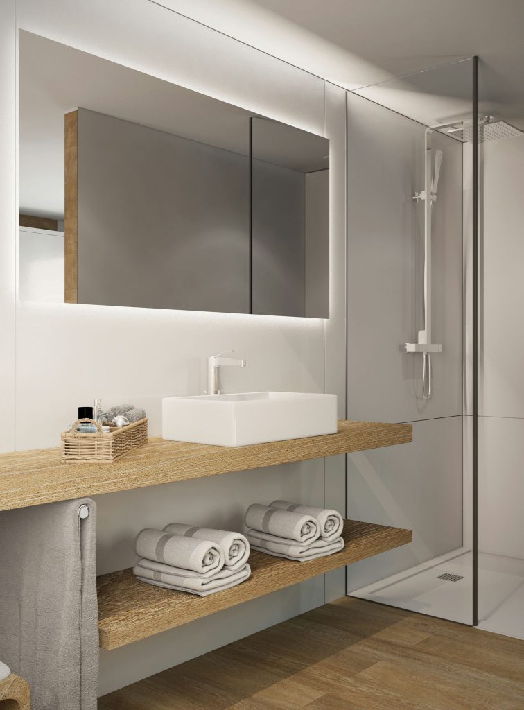 Baño Moderno y Elegante con Diseño Minimalista en Barcelona Interior de baño moderno y elegante con diseño minimalista, que presenta una encimera de madera, lavabo cuadrado blanco y toallas grises organizadas. La iluminación natural resalta los materiales de cristal y madera en un ambiente contemporáneo típico de la arquitectura de alta gama en Barcelona.