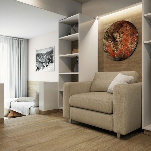 Sala de estar con un sillón beige y arte abstracto en la pared, destacando la arquitectura de alta gama en Barcelona