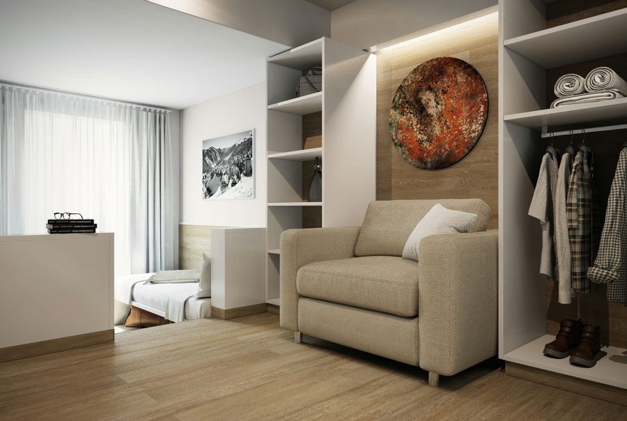 Sala de estar con un sillón beige y arte abstracto en la pared, destacando la arquitectura de alta gama en Barcelona