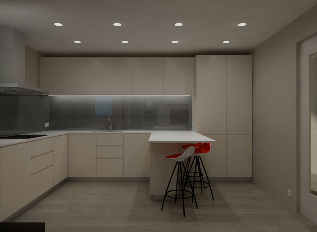 Cocina Moderna en Barcelona con Diseño Funcional y Estético Cocina contemporánea en Barcelona que destaca por sus armarios en tonos claros, una amplia encimera blanca y taburetes de bar minimalistas en negro y rojo. Iluminación perfecta con luces de techo empotradas, enfatizando el uso de materiales de alta calidad como madera y cristal.
