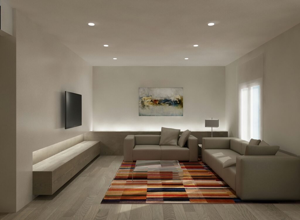 Interior de una moderna sala de estar en Barcelona, con un sofá seccional elegante y una alfombra geométrica colorida, resaltando la arquitectura contemporánea y la funcionalidad en el diseño.