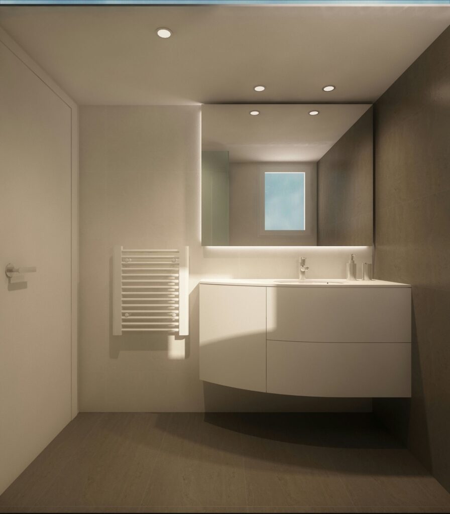 Diseño de interiores modernos en un baño de lujo en Barcelona Baño moderno con diseño elegante en Barcelona, que presenta un vanitory blanco curvo con dos lavabos, un espejo minimalista y luminarias contemporáneas, iluminado con luz natural y acentuado con mármol y paredes texturizadas.