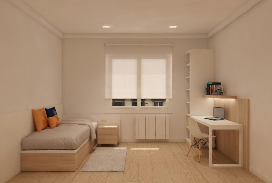 Dormitorio moderno en Barcelona con cama sencilla, cojines naranjas y azules, mesa de noche simple y escritorio con laptop. Espacio minimalista iluminado por luz natural, con suelo de madera y muebles elegantes que reflejan funcionalidad y estilo.