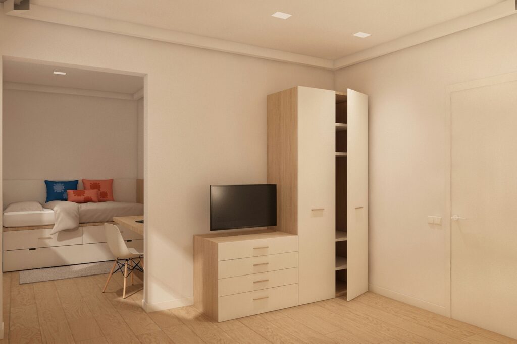 Diseño de interiores moderno en Barcelona con materiales de alta calidad Interiores contemporáneos en Barcelona que muestran un espacio estilizado con muebles de madera clara y una paleta de colores neutra, resaltando funcionalidad y estética.