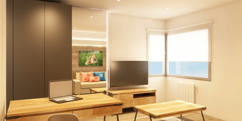 Diseño de interiores moderno en Barcelona que muestra una sala de estar elegante y un espacio de trabajo funcional. Espacio iluminado por luz natural con materiales de alta calidad como madera y vidrio.