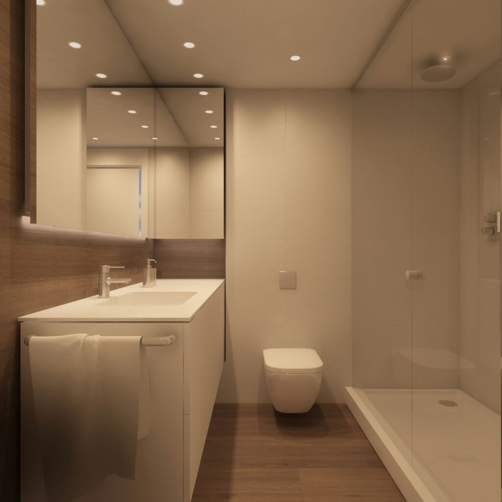 Diseño de baño moderno en Barcelona con acabados de alta gama Baño moderno y elegante en Barcelona, con un mueble minimalista, encimera blanca, grifos elegantes, y una gran ducha de cristal.