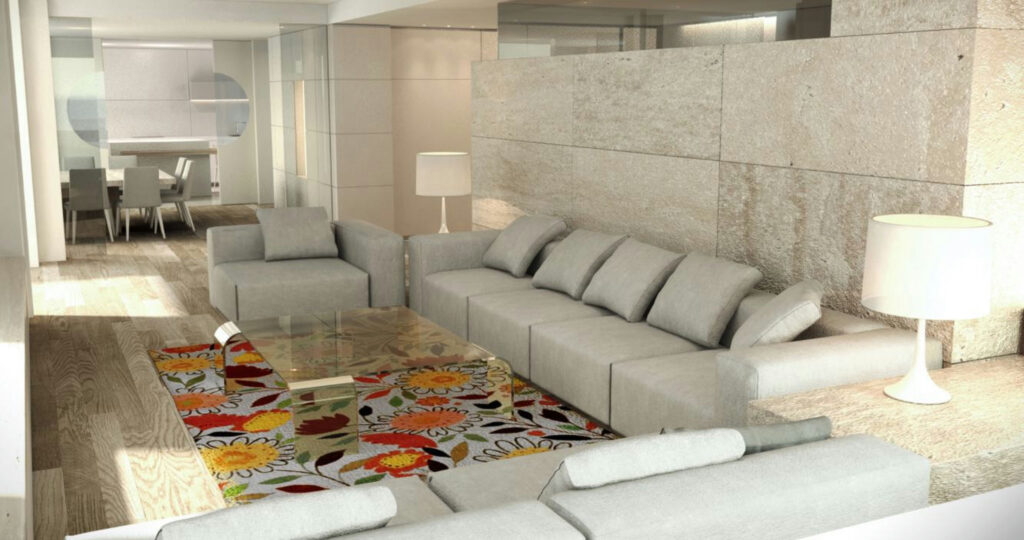 Moderno salón de diseño de interiores en Barcelona con muebles de alta gama Salón contemporáneo en Barcelona con sofá gris claro, mesa de cristal y alfombra floral, destacando iluminación natural y detalles arquitectónicos de alta calidad.