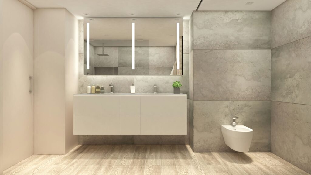 Baño Moderno y Lujo en Barcelona - Diseño de Interiores Baño moderno y lujoso en Barcelona con diseño arquitectónico de alta gama, featuring cabinetry blanca, paredes de piedra gris y piso de madera cálida, iluminado naturalmente con instalaciones minimalistas.
