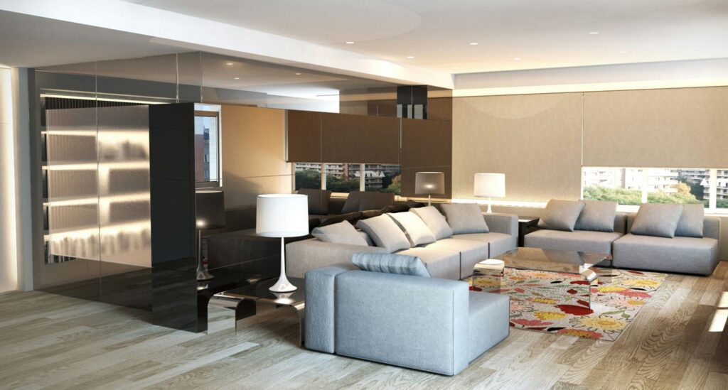 Diseño de interiores contemporáneo en Barcelona: salón elegante y funcional Moderna sala de estar en Barcelona con sofá gris y almohadas blancas, iluminada por luz natural a través de paredes de vidrio. Destacan los elementos de madera, una pared de acento negra y una alfombra floral.