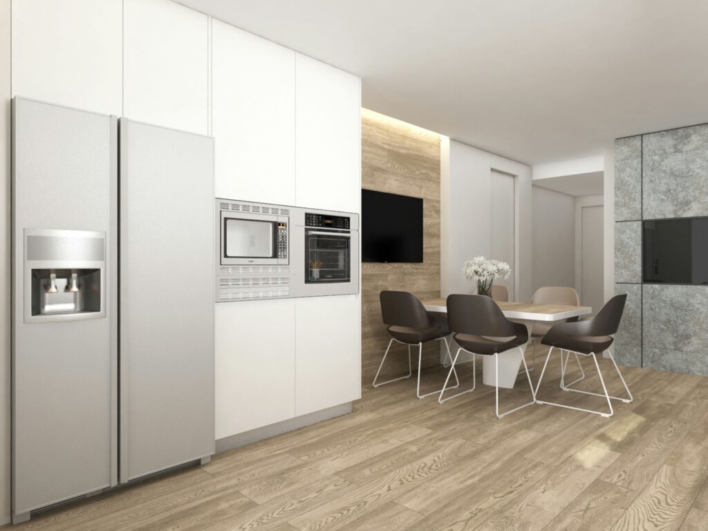 Cocina Moderna y Contemporánea en Barcelona con Estilo Minimalista Diseño de interiores contemporáneo de una cocina moderna en Barcelona, destacando electrodomésticos de acero inoxidable, armarios blancos y una mesa de comedor blanca con sillas modernas en un entorno de iluminación natural.
