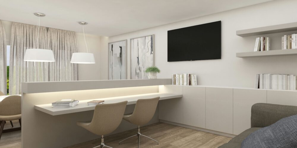 Moderno diseño de interiores en Barcelona que presenta un espacio funcional y estético con una mesa de trabajo blanca iluminada, sillas contemporáneas, decoraciones sencillas y grandes ventanas que permiten la entrada de luz natural. Incluye un área de almacenamiento minimalista y un televisor en la pared, con suelo de madera y cojines de colores en un sofá, reflejando alta calidad en los materiales utilizados.