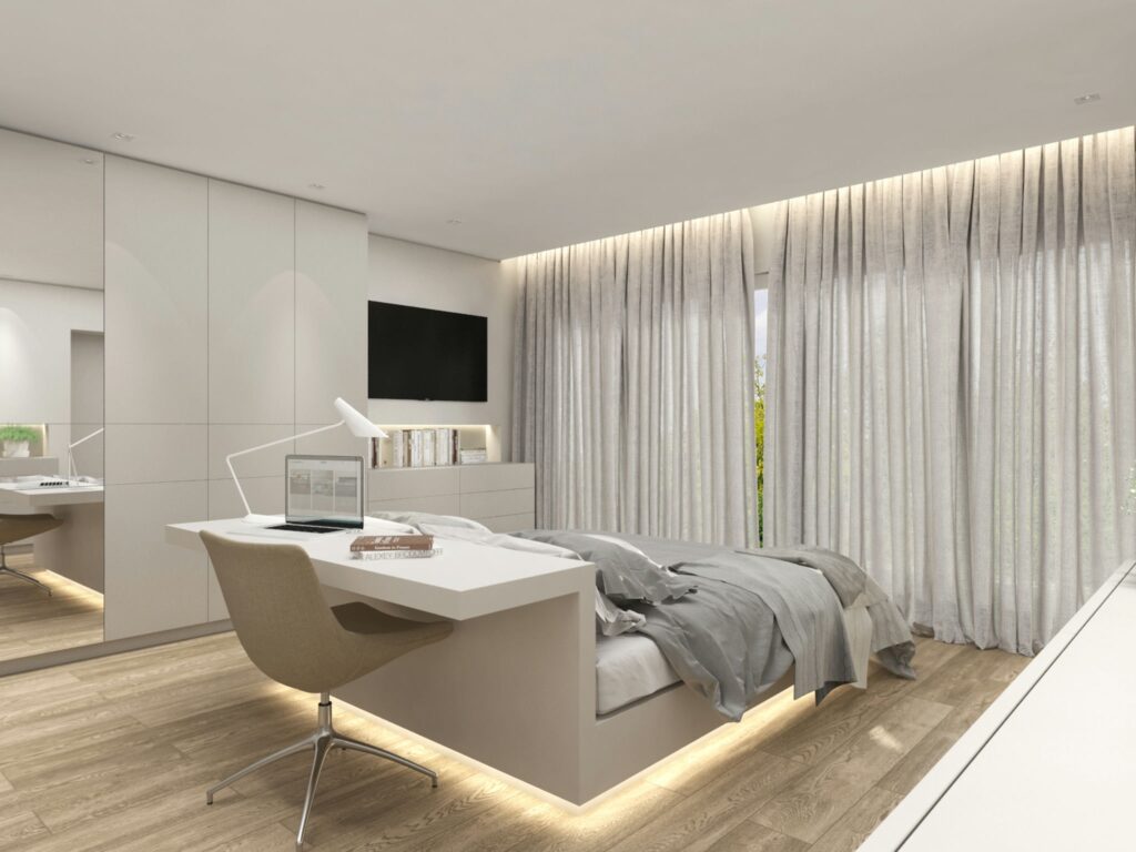 Diseño de interiores moderno en Barcelona: dormitorio minimalista de alta gama Interiores de un dormitorio contemporáneo en Barcelona con un diseño minimalista que destaca la funcionalidad y materiales de alta calidad. El espacio incluye un escritorio moderno, una cama elegante y grandes ventanas que permiten la entrada de luz natural.