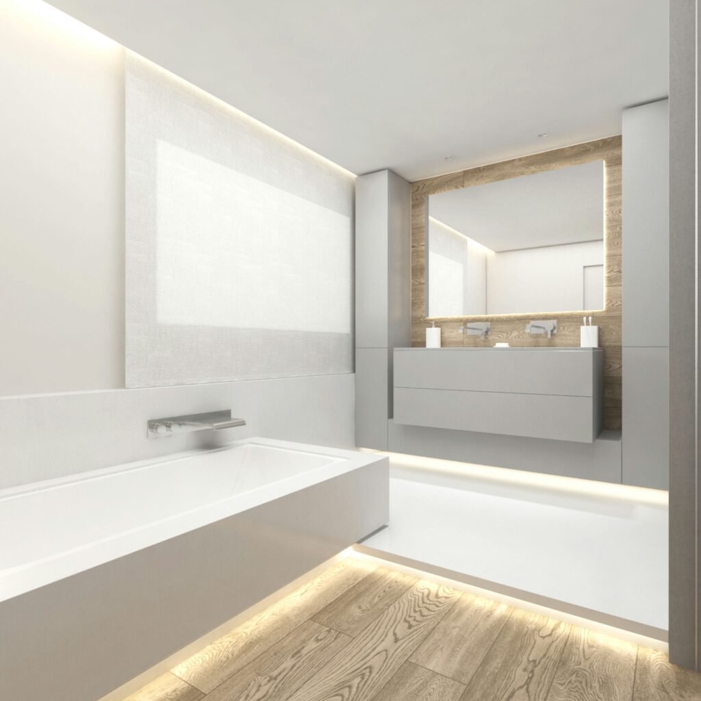 Diseño de Baño Moderno y Contemporáneo en Barcelona Baño contemporáneo en Barcelona con bañera blanca moderna, tocador gris minimalista y acentos de madera, resaltado por iluminación LED.