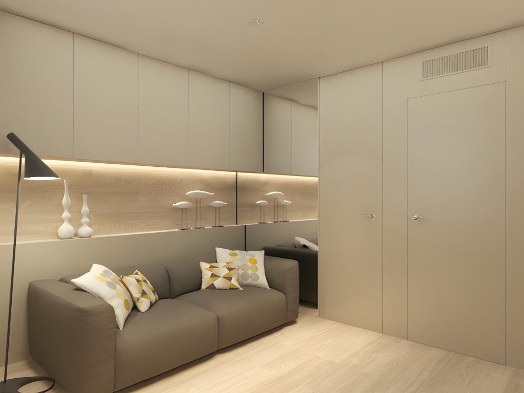 Diseño de interiores moderno en Barcelona - Espacio contemporáneo de alta gama Moderno espacio interior en Barcelona con un sofá gris, cojines decorativos, lámpara de pie elegante y estanterías iluminadas. Destaca el uso de materiales de calidad como madera y cristal en un diseño funcional y estético.