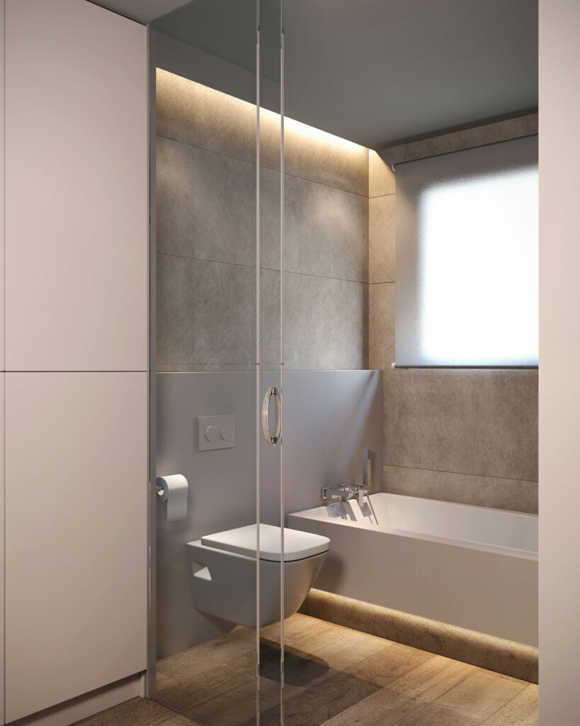 Diseño de interiores de baño moderno en Barcelona con mármol y madera Baño contemporáneo en Barcelona que combina mármol y madera, con iluminación natural y diseño minimalista. Presenta una bañera elegante, inodoro suspendido, y detalles arquitectónicos sofisticados que reflejan funcionalidad y estética de alta gama.
