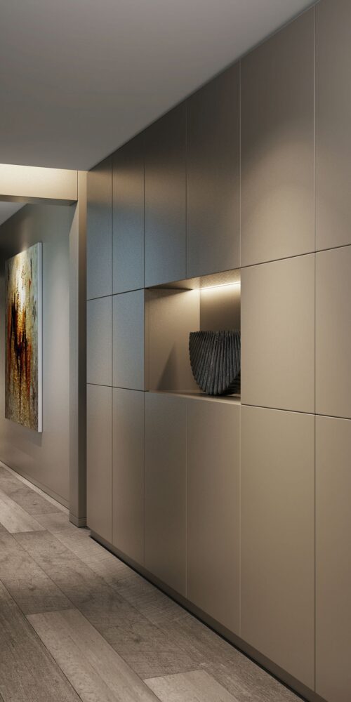 Corredor moderno en un proyecto de arquitectura de alta gama en Barcelona, con paneles claros, suelo de madera elegante, iluminación ambiental y obra de arte decorativa.