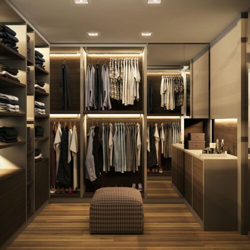 Vestidores: Espacio de closet elegante y funcional con estanterías organizadas, iluminación LED cálida y mobiliario personalizado, representando la arquitectura contemporánea de Barcelona.