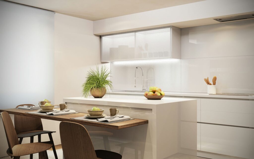 Cocina de Diseño Moderno en Barcelona con Acabados en Madera y Mármol Moderna cocina de diseño interior en Barcelona, destacando una isla central blanca, mesa de madera, utensilios de cocina y frutera con manzanas, iluminada de manera natural.