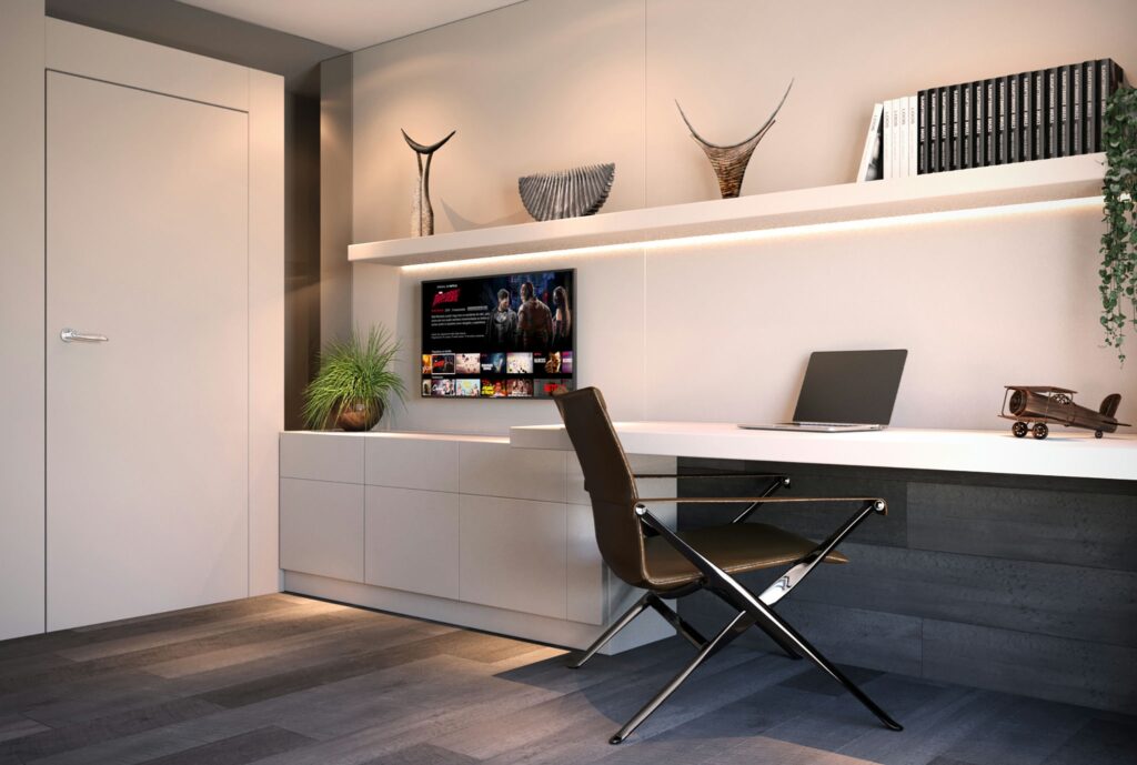 Diseño de Oficina Moderna en Barcelona - Proyecto de Interiorismo de Alta Gama Oficina moderna en Barcelona con escritorio blanco, silla negra, estante flotante y pantalla de televisión, iluminada con luz natural
