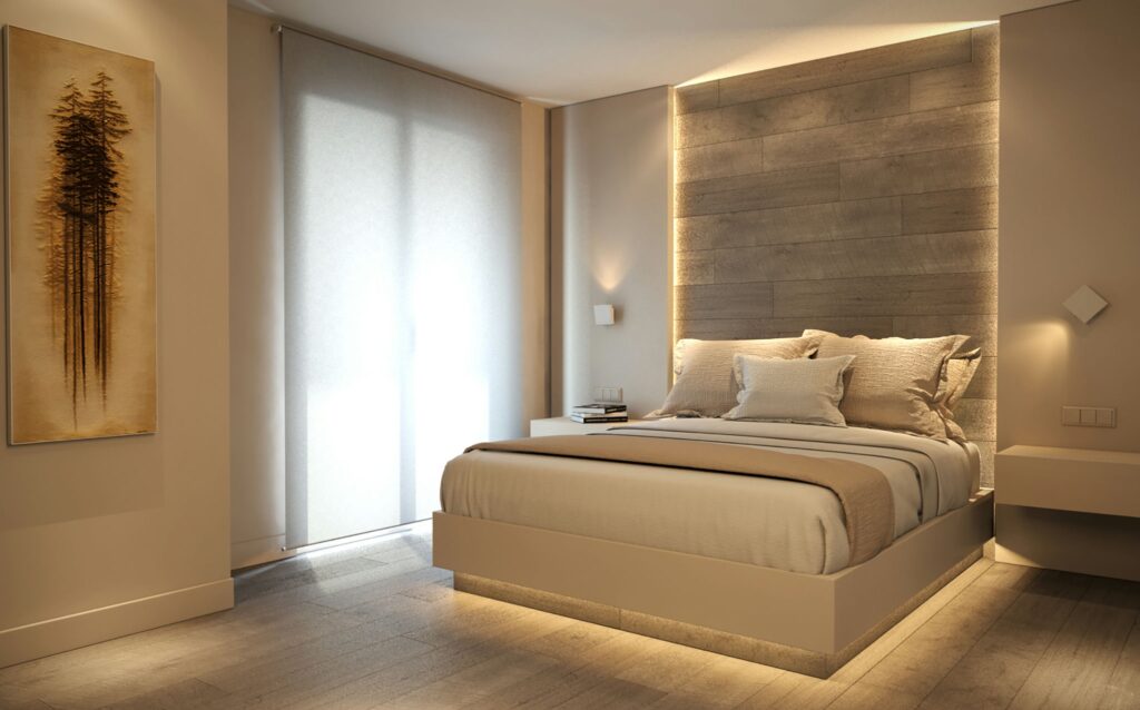Diseño de interiores moderno en Barcelona: dormitorio de alta gama Diseño de interiores de un dormitorio moderno de alta gama en Barcelona, con una cama contemporánea en tonos madera clara y beige, iluminación natural proveniente de grandes ventanas, arte en las paredes, y mobiliario minimalista destacando la funcionalidad y materiales de calidad.