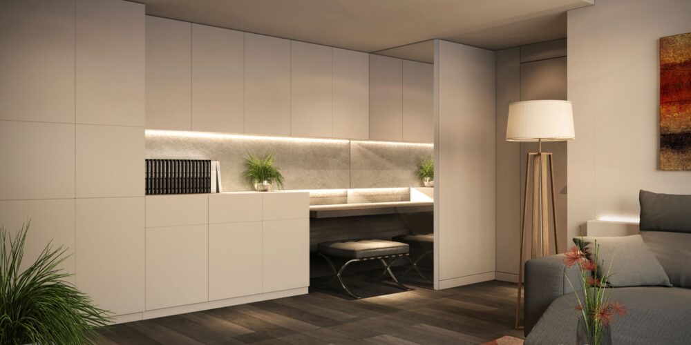Oficina moderna en Barcelona con mobiliario contemporáneo y acabados en mármol. Destacan la iluminación LED sutil, un escritorio elegante y un sofá gris, todo rodeado de vegetación que aporta calidez al espacio.