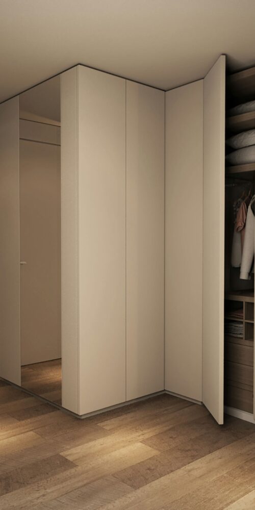 Almacenamiento moderno con gabinetes beige, superficies espejadas y suelo de madera en un interior elegante, representando arquitectura de alta gama en Barcelona.