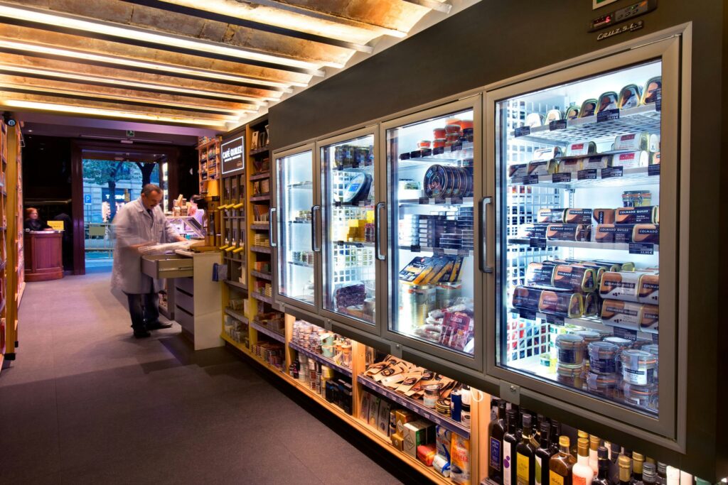 Interior de Tienda Gourmet en Barcelona con Diseño Moderno Diseño contemporáneo de un espacio de alta gama en Barcelona, mostrando estanterías modernas y refrigeradores de cristal con productos gourmet.
